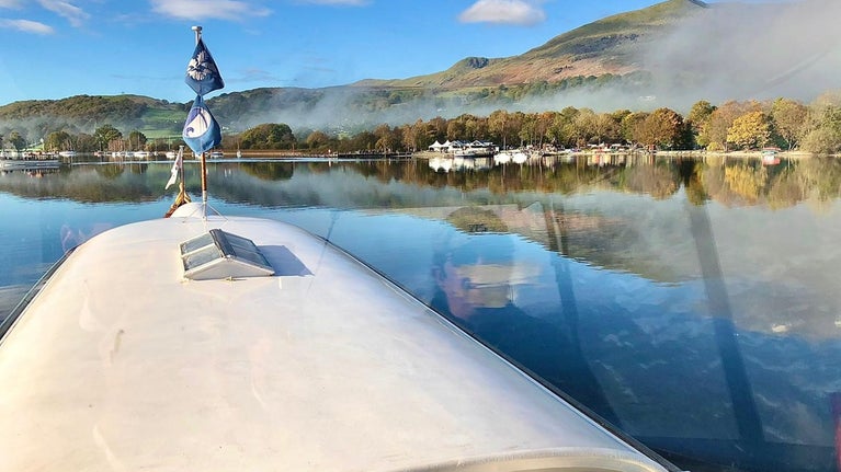 An autumnal scene from the deck of Gondola showing her steaming down the lake